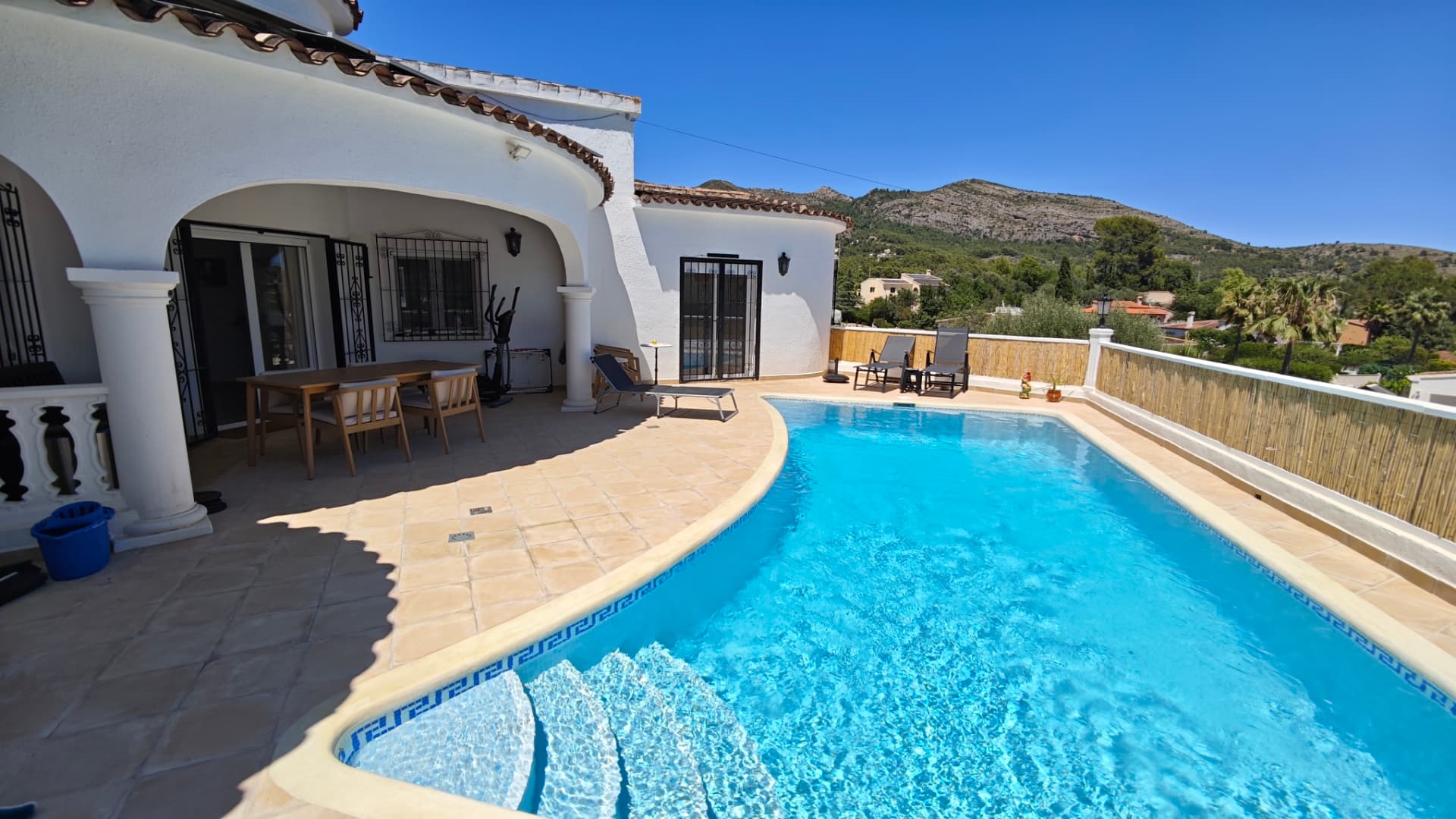 Terraza con piscina y zona de comedor exterior en la Costa Blanca